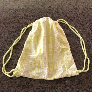 Claire’s drawstring sack pack with zipper pocket.